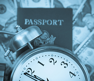 Clock on top of Passport and cash